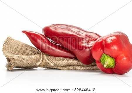 Group Of Three Whole Sweet Red Bell Pepper With Jute Bag Isolated On White Background