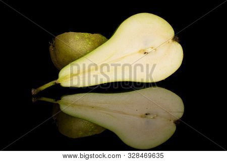 Group Of Two Halves Of Fresh Green Pear Isolated On Black Glass