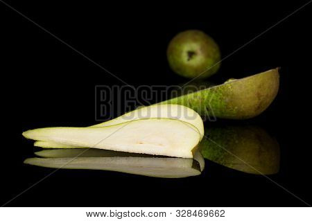 Group Of One Whole One Half Two Slices Of Fresh Green Pear Isolated On Black Glass