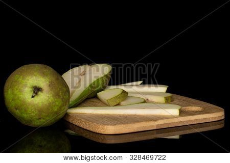 Group Of One Whole One Half Five Slices Of Fresh Green Pear On Bamboo Cutting Board Isolated On Blac