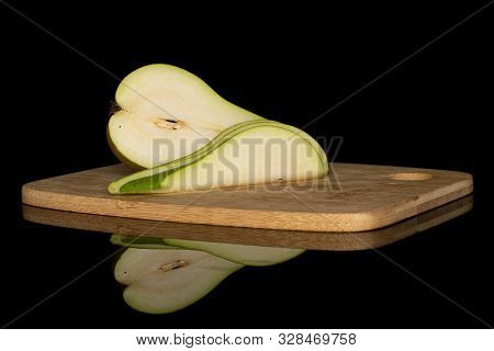 Group Of One Half Two Slices Of Fresh Green Pear On Bamboo Cutting Board Isolated On Black Glass