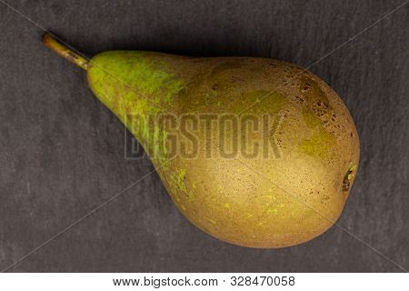 One Whole Fresh Green Pear Flatlay On Grey Stone