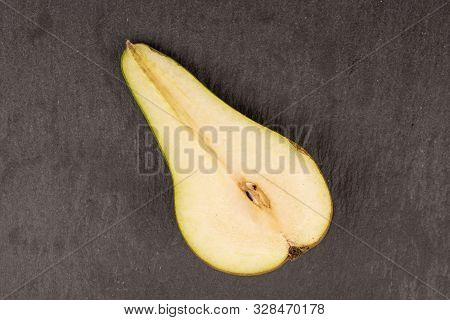 One Half Of Fresh Green Pear Flatlay On Grey Stone