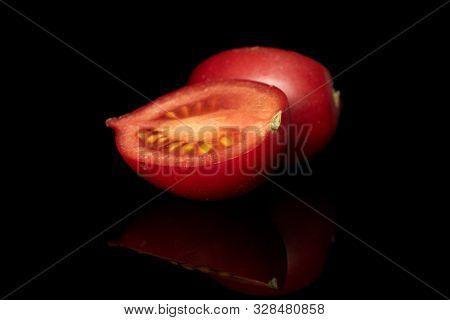 Group Of Two Halves Of Fresh Tomato De Barao Isolated On Black Glass