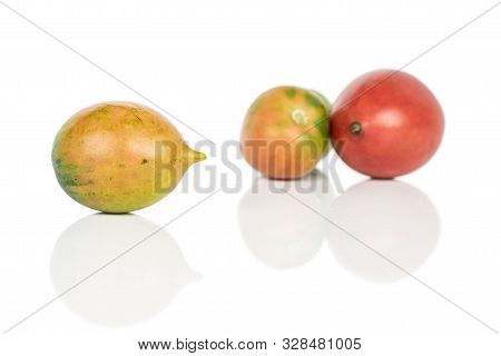 Group Of Three Whole Fresh Tomato De Barao Isolated On White Background