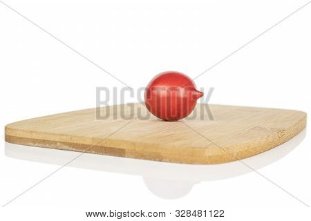 One Whole Fresh Tomato De Barao On Bamboo Cutting Board Isolated On White Background