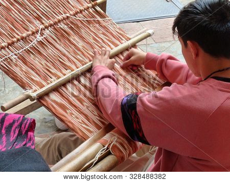 Cuenca, Ecuador - March 8, 2019: Ecuadorian Man Is Weaving Scarf Or Macana By Hand With Cotton Threa