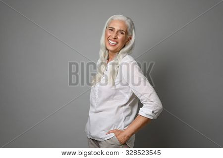 Portrait Of Beautiful Mature Woman On Grey Background