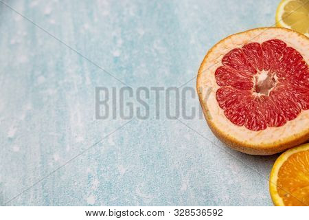 Bright Slices Of Oranges And Grapefruit On A Blue Background