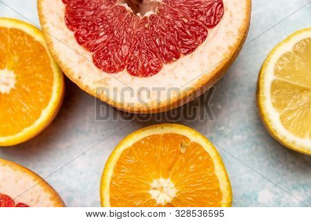 Bright Slices Of Oranges And Grapefruit On A Blue Background