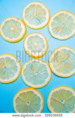 Slices Of Lemons On A Blue Background