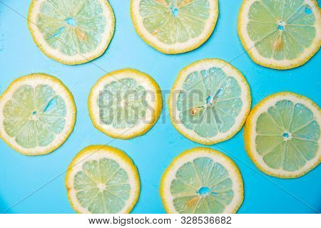 Slices Of Lemons On A Blue Background