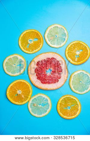 Bright Slices Of Oranges And Grapefruit On A Blue Background