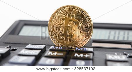 Bitcoin On The Keyboard Of The Calculator. Shallow Depth Of Field. A Visual Representation Of Digita