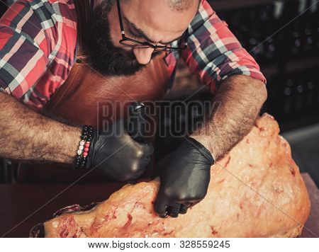 Chef cutting beef carcass in a restaurant