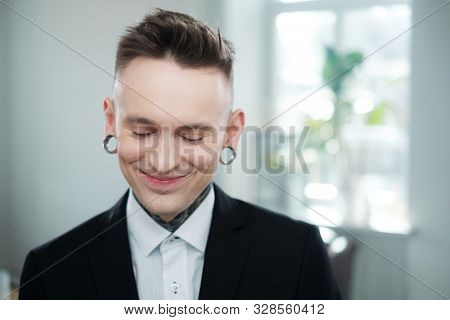 Portrait of alternative model with earplugs and tattoo