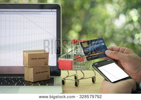 Closeup Man Hand Holding Smartphone And Credit Card Making Payment. Man Doing Shopping Online On Mob