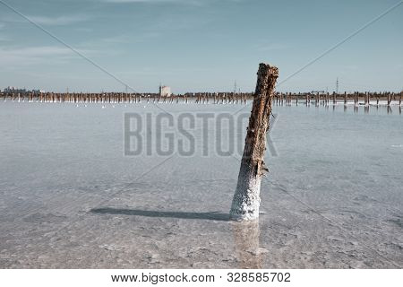 Salt Lake With Mud Baths. Treatment In A Salt Lake. Sanatorium. Wooden Posts For Salt Mining