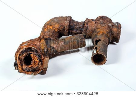 Fragments Of Old Cast-iron Water Pipes On White Background. After Many Years Of Operation Corroded M