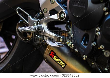 A Close-up Photo Of Akrapovic Exhaust Muffler On Custom Motorcycle In Bucharest, Romania, 2019