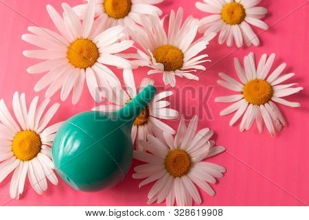 Green Douche Enema Bowel Washing, Rinse Mouth, Nose Top View On A Pink Background