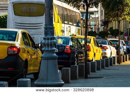Car Traffic At Rush Hour In Downtown Area, Victoriei Boulevard (calea Victoriei) In Bucharest, Roman
