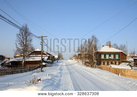 Snow-covered Country Road In Winter. View Of The Old Residential Neighborhood. Village Of Visim, Sve