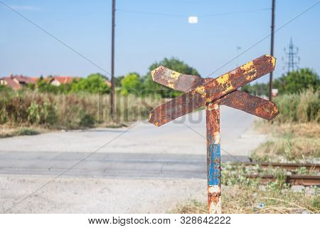 Level Crossing Sign, Called Crossbuck, Saltire Or Saint Andrews Cross, Rusted, Standing On A Country