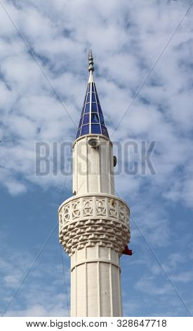 Minarett with blue top of a mosque in Turkey