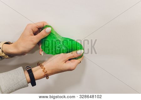 Slime, Green Pate Elastic And Vicous On Childs Hand.