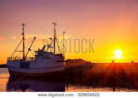 Fishing boats in harbor at midnight sun in Northern Norway, Lofoten Island, Ramberg, Norway