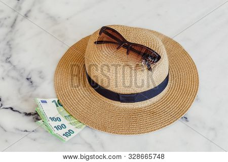 Sun Hat With Sunglasses And 100 Hundredth Euro Banknotes. Money Or Vacation Concept