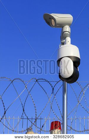 Perimeter Security. Barbed Wire Fencing, A Red Signal Light And Camera Protect Against Intrusions.