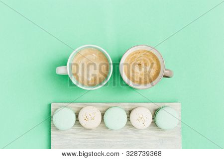 Fashion Flat Lay With Two Cup Of Coffee And Tasty Macaroons On Trend Color Mint Background With Copy
