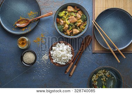 Eating Chinese Food With Rice, Salmon And Vegetables