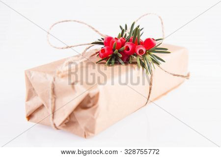 Gift Decorated With A Gunny String Bow And With A Common Yew Twig