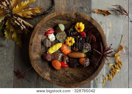 Autumn Chocolate Bonbon On A Wooden Dish