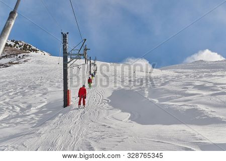 Using ski lift to get to the top of ski slopes