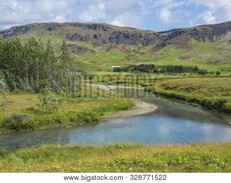 Idyllic Landscape Of Hveragerdi Near Reykjadalur Valley With Hot Springs River, Lush Green Grass Mea