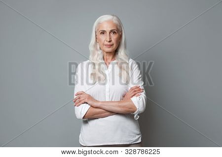 Portrait Of Beautiful Mature Woman On Grey Background