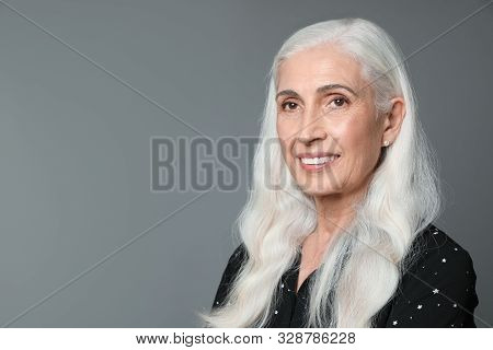 Portrait Of Beautiful Mature Woman On Grey Background, Space For Text