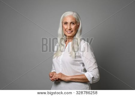 Portrait Of Beautiful Mature Woman On Grey Background