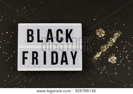 Black Friday Sale Text On White Lightbox, Golden Stars Around On Black Background