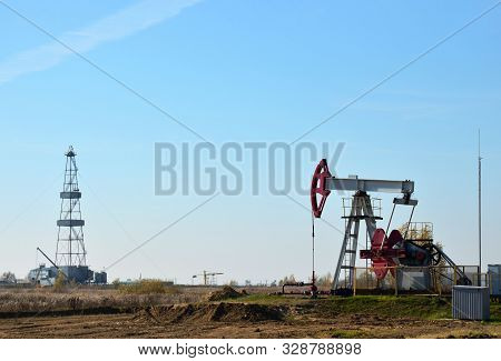 Oil Drilling Derricks At Desert Oilfield. Crude Oil Production From The Ground. Oilfield Services Co