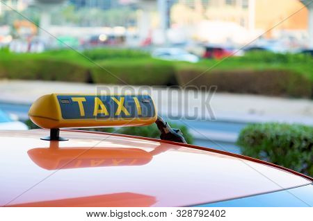 Taxi Car Is Waiting For A Passenger On The Street In Dubai, United Arab Emirates.