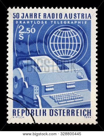 ZAGREB, CROATIA - JULY 03, 2014: A stamp issued in the Austria shows Telex and globe, the 50th Anniversary of Radio Austria, circa 1974.