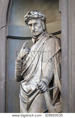 FLORENCE, ITALY - JANUARY 11, 2019: Dante Alighieri in the Niches of the Uffizi Colonnade. The first half of the 19th Century they were occupied by 28 statues of famous people in Florence, Italy