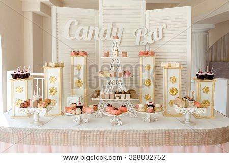 Candy Bar. Delicious Sweet Buffet With Cupcakes. Sweet Holiday Buffet With Cupcakes And Other Desser