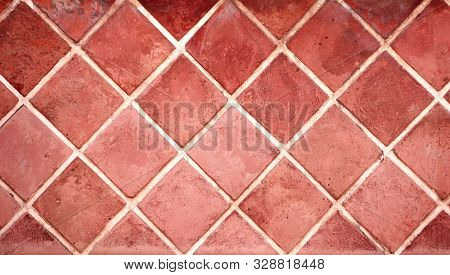 Old porcelain tiles floor texture with tiles of red color and cement of white color
