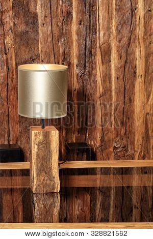 Beautiful Modern Lamp Made Of Old Wood In The Form Of A Table Lamp Stands And Is Reflected On A Poli